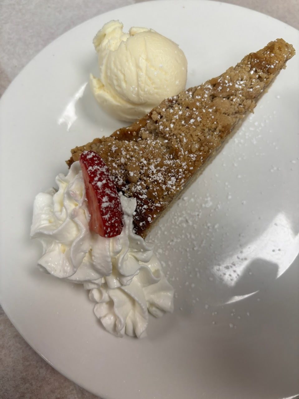 Dessert slice with ice cream and a strawberry