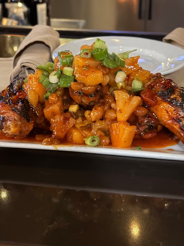 Glazed chicken wings with pineapple and scallions